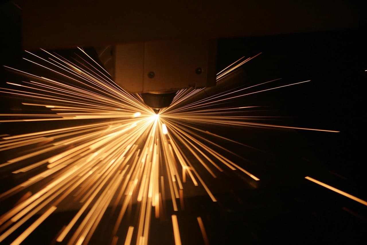 Sparks flying from a laser cutting machine, the kind of process a good product page explains in plain text