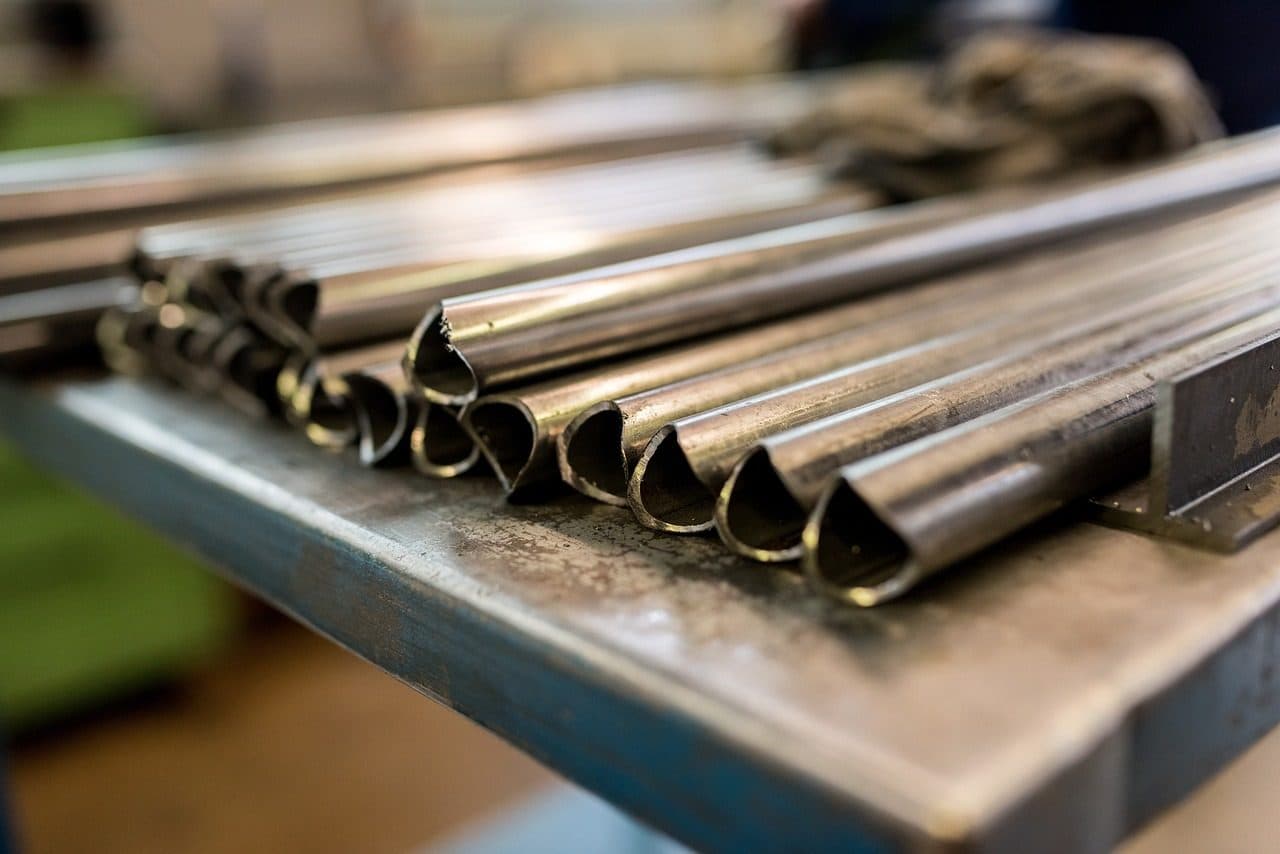 Close-up of stainless steel tubes on a workbench