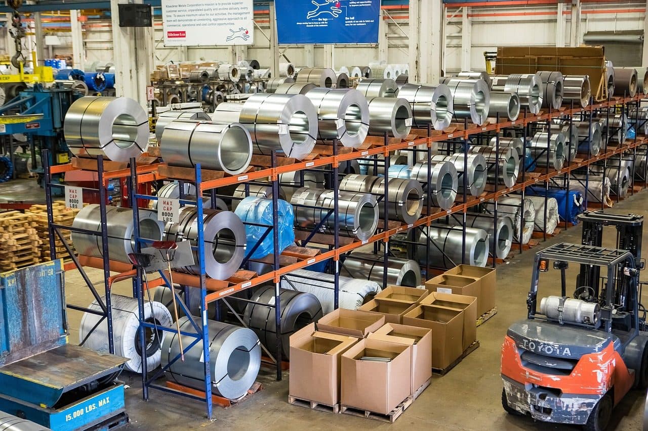 Steel coils stored on warehouse racks at a metal manufacturer