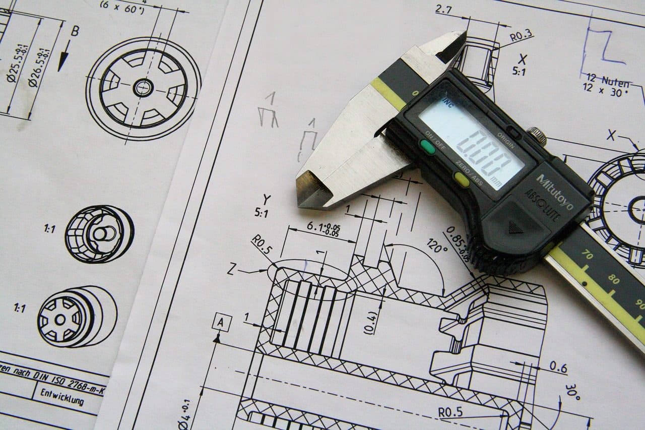 Technical drawing with digital calipers on a workbench, the kind of detail manufacturers should turn into content